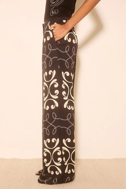 Woman wears a black and white print matching set