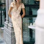 model wears a cream floral dress