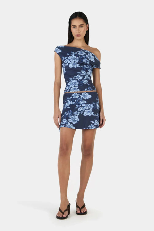 Model wearing a blue floral print skirt and top set