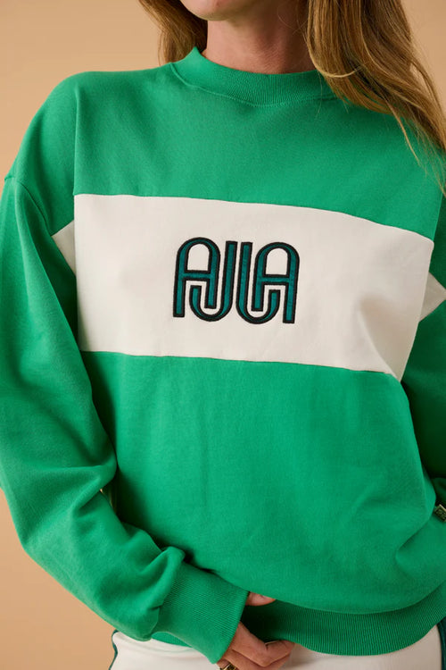 green and white sweater with text on front
