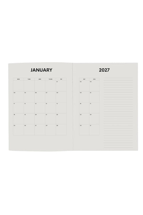 An open monthly calendar spread showing January 2027, with a grid calendar on the left page and lined writing space on the right page, photographed on a plain white background.