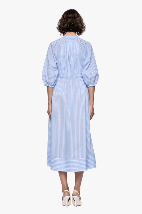woman wearing a blue and white striped midi shirt dress