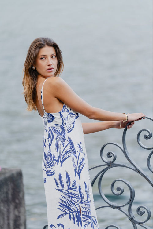 model wears a white and blue floral midi dress