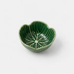 A small green ceramic bowl with a lotus petal shape and a leaf vein pattern printed inside, shown on a light gray background.