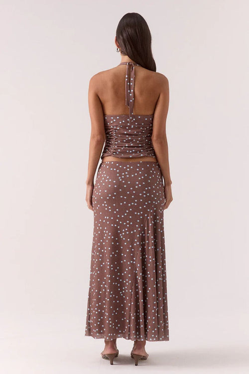 Woman wearing a brown and blue polka dot skirt and top set 