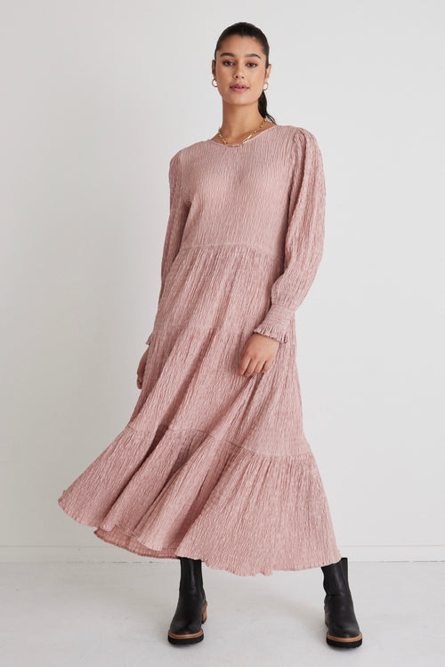 model wears a pink long sleeve dress