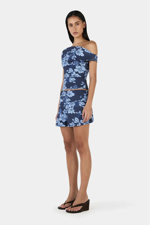 Model wearing a blue floral print skirt and top set