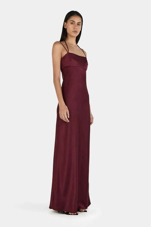 Model wears a burgundy event dress