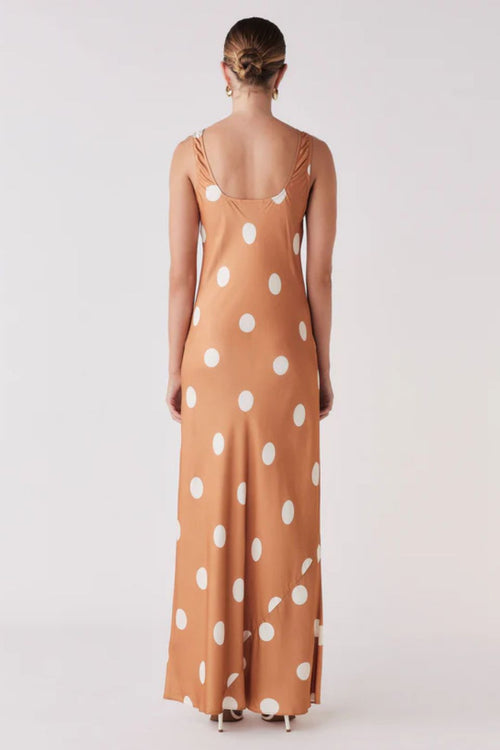 Woman wearing a brown and white spot dress 