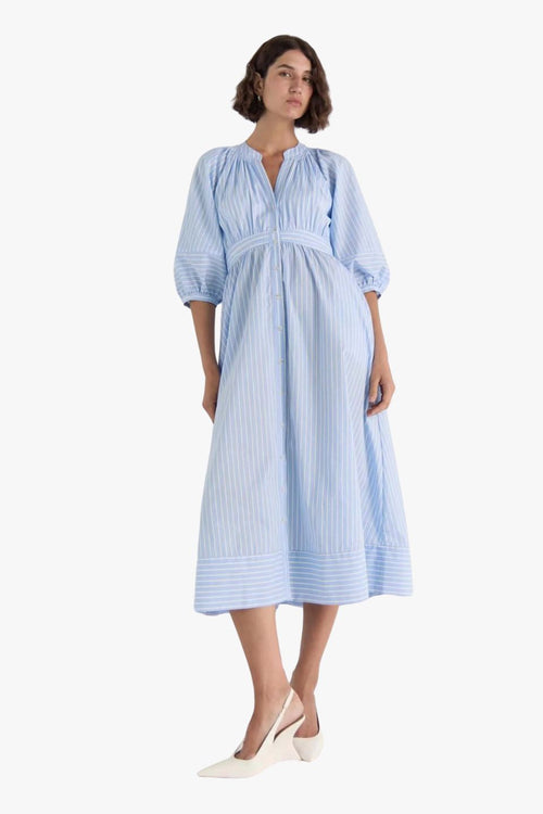 woman wearing a blue and white striped midi shirt dress