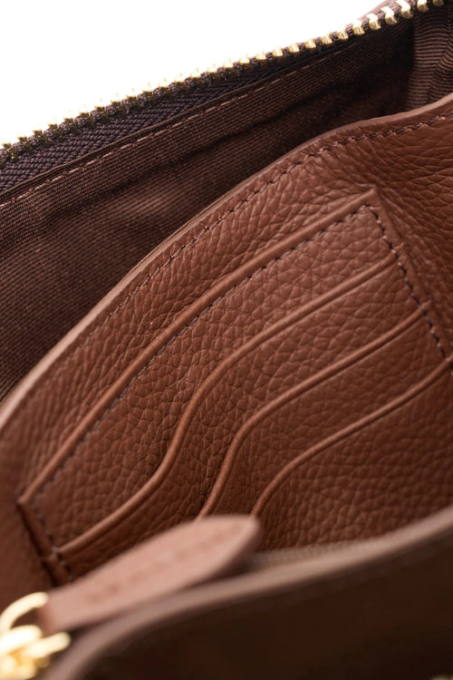 Close-up of a brown leather pouch with a zipper