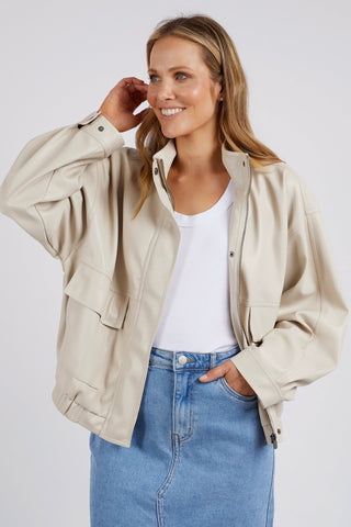model wears a beige jacket