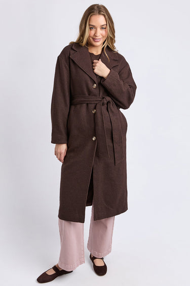 Woman wearing a brown coat on a white background