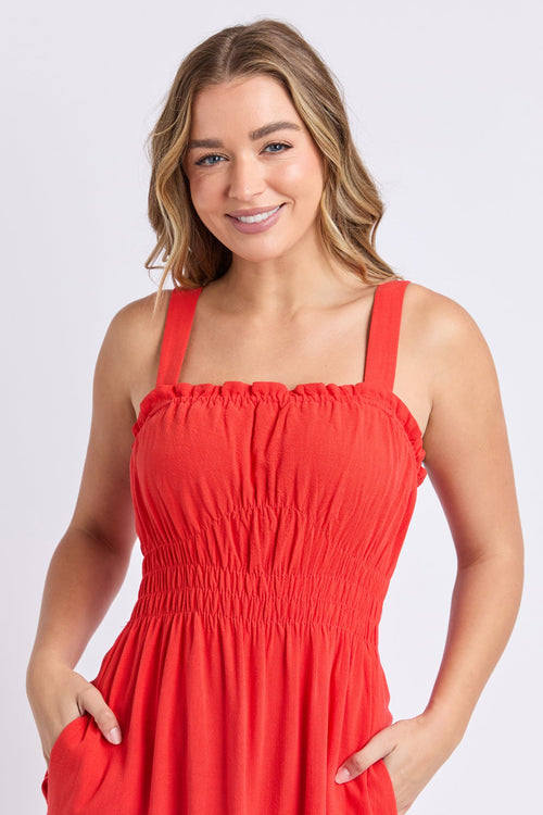 Woman wears a orange red maxi dress