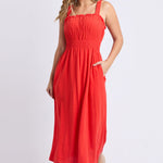 Woman wears a orange red maxi dress