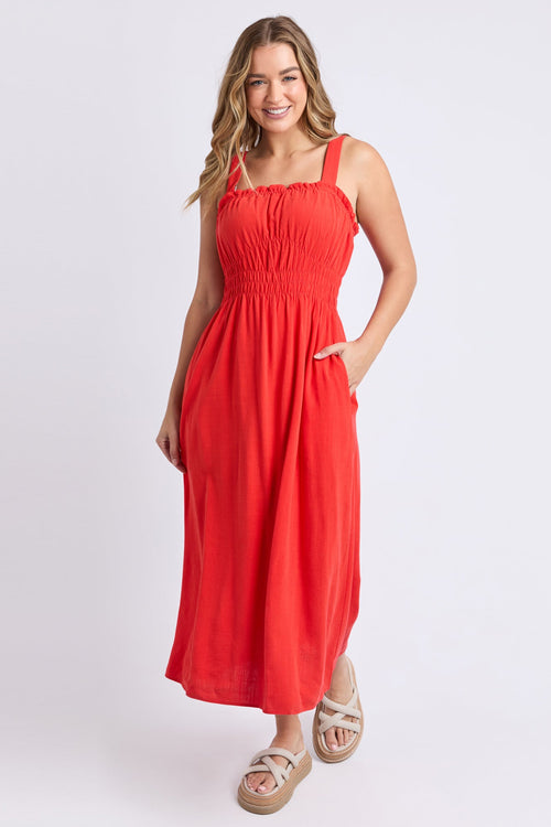 Woman wears a orange red maxi dress