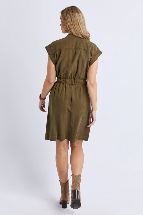 Woman wearing a green dress with a belt on a white background