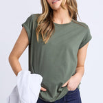 Woman wearing a green scoop neck tee and dark blue jeans