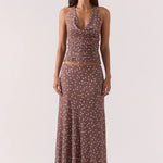 Woman wearing a brown and blue polka dot skirt and top set 