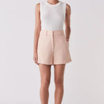 Woman wearing a pink short and white tank top