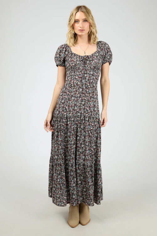 Woman wearing a dark purple floral maxi dress