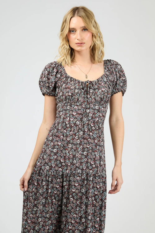 Woman wearing a dark purple floral maxi dress