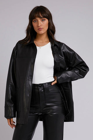 model wears a black leather shacket