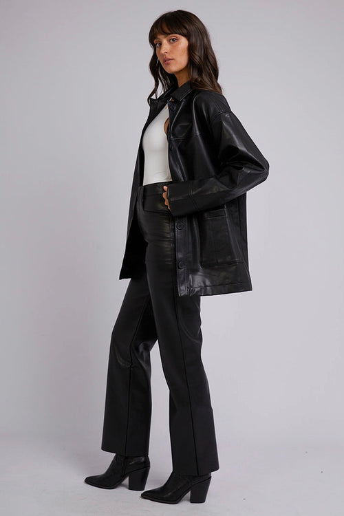 model wears a black leather shacket