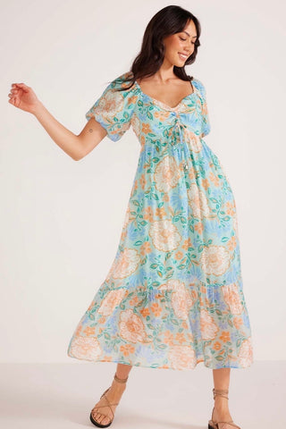 Model wears a blue floral maxi dress