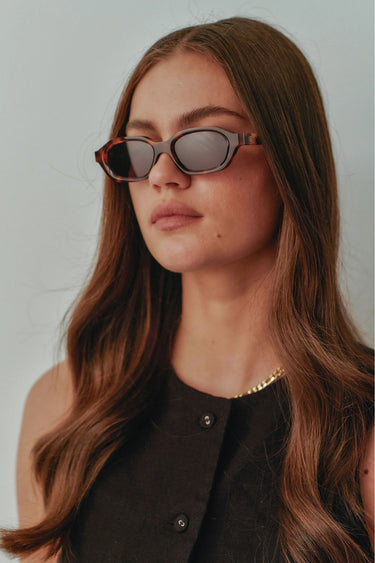 model wears a brown tort sunglass