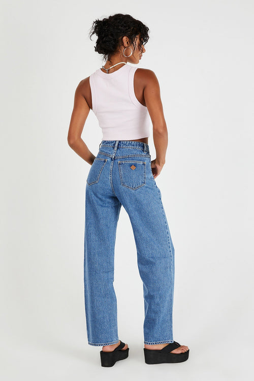 model wears blue straight leg jeans