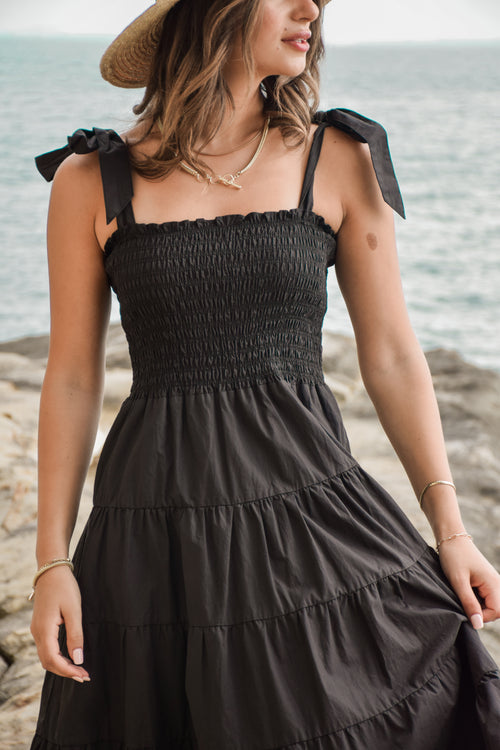 model posing outside in long black maxi dress