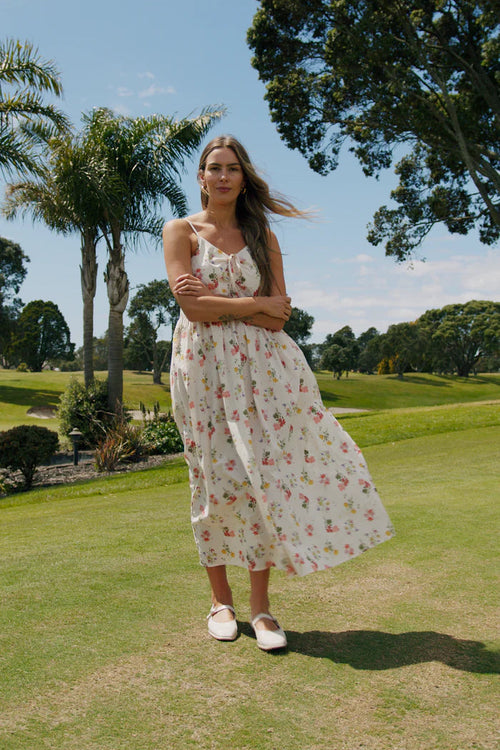 Woman wearing a floral cream long dress