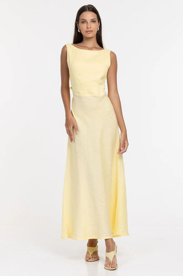 Woman wearing a light yellow dress on a white background