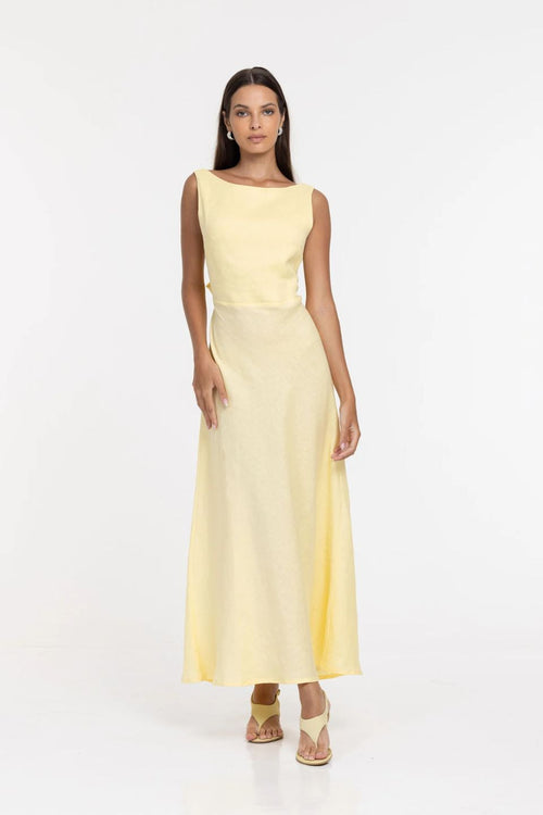 Woman wearing a light yellow dress on a white background