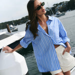 model wearing blue and white stripe shirt with shorts 