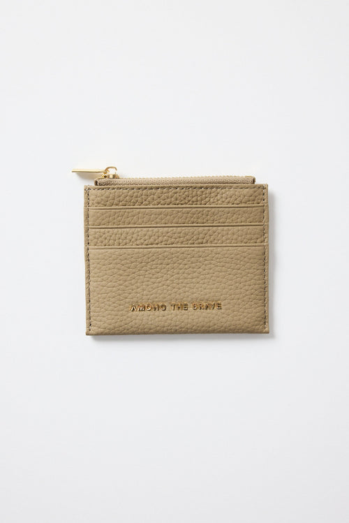 Beige cardholder with gold zipper on a light gray background