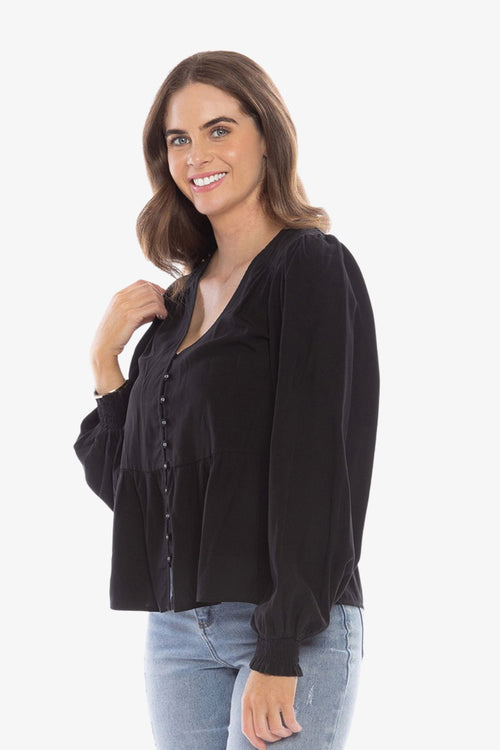 model in long sleeve black v neck blouse
