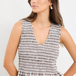 Chocolate gingham sleeveless shell top with frill hem, styled with cream jeans