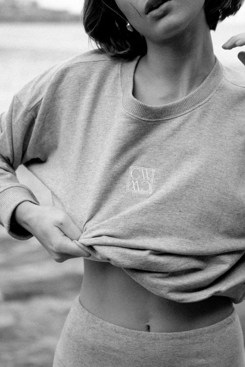 model wears a grey crew sweater