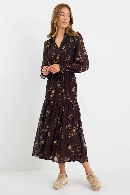 Woman wearing a black floral dress on a white background
