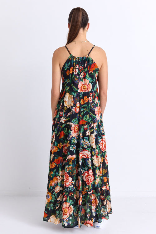 model wears a black floral maxi dress