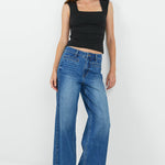 Women wearing wash blue jean and black tank