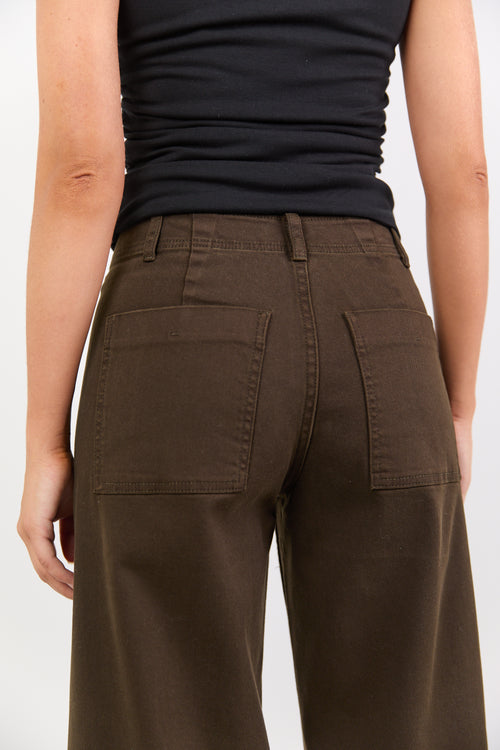 Person wearing brown pants and a black top on a white background
col_pattern