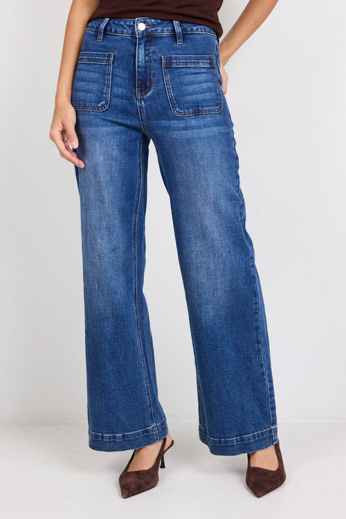 Person wearing blue jeans on a white background