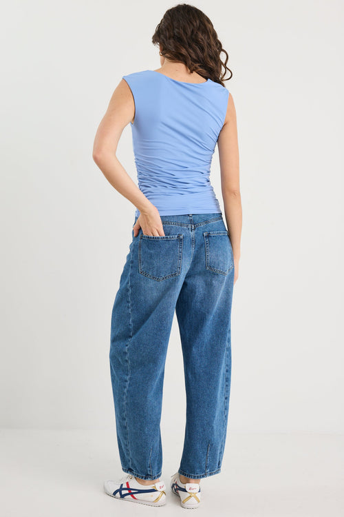 Woman wearing a blue top and blue jean