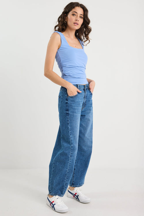 Woman wearing a blue top and blue jean