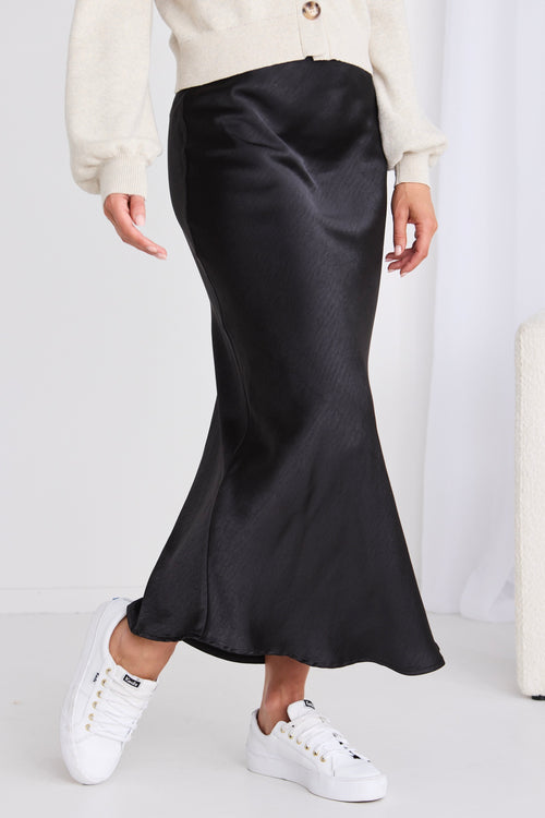 model wears a black maxi skirt