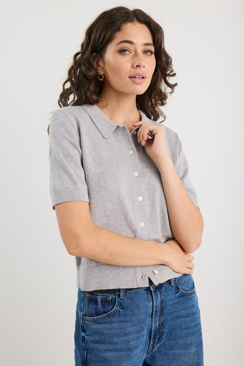 Woman wearing grey knit and blue jeans