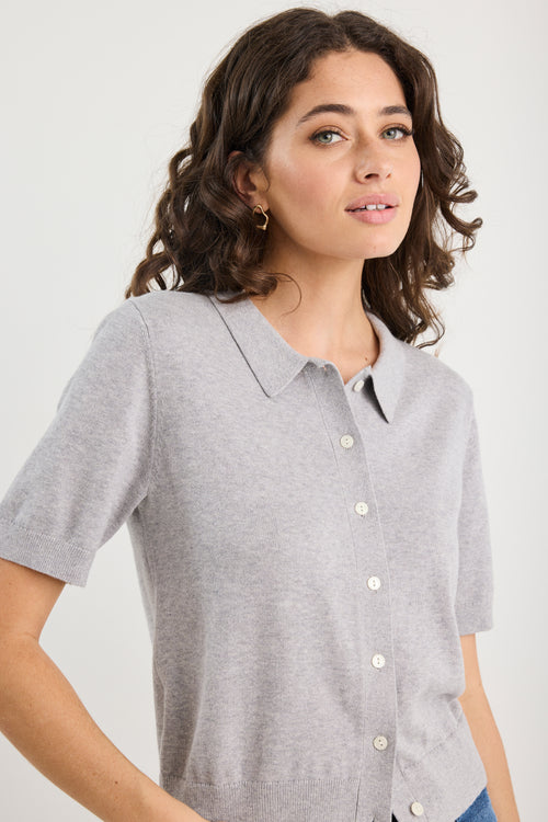 Woman wearing grey knit and blue jeans